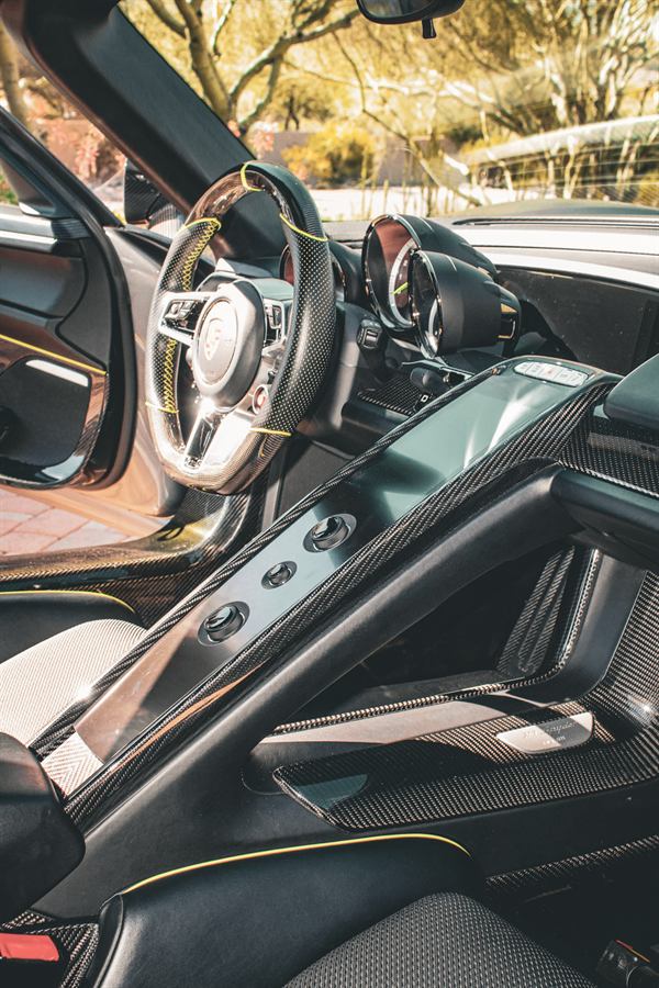 Carbon fibre cockpit of a Porsche 918 Spyder with acid green stitching