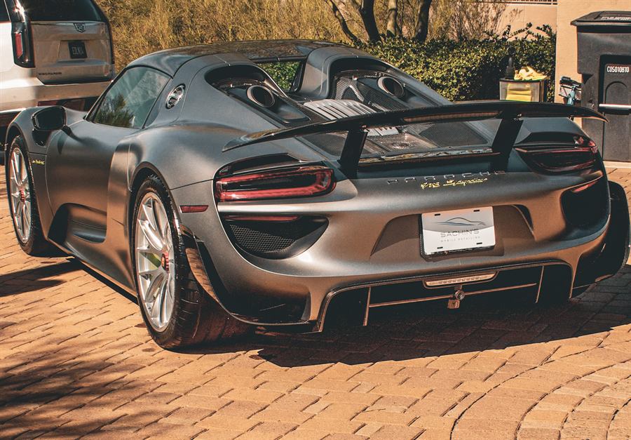 Porsche 918 Spyder rear three-quarter view on brick pavers after correction