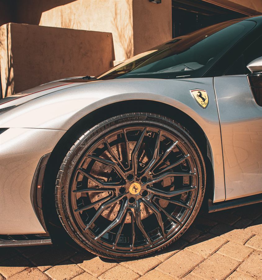 Silver Ferrari front wheel and carbon fibre arch after cleaning