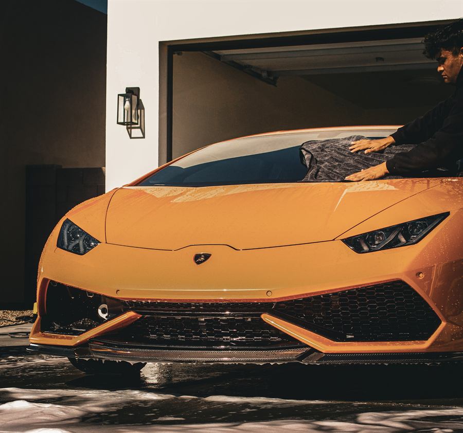 Front end of an orange Lamborghini Huracán after a full detail