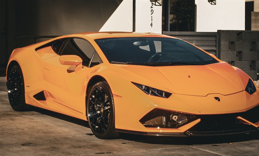 Orange Lamborghini Huracán side profile with a deep gloss finish